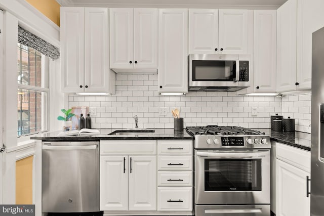 1833 S St NW Unit 2, Washington, DC 20009 - kitchen with appliances with stainless steel finishes, white cabinetry, decorative backsplash, and dark stone counters