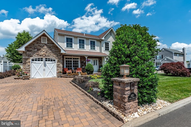 1421 Custom House Sq, Bensalem, PA 19020 - view of front of home with stone siding, a porch, decorative driveway, and an attached garage