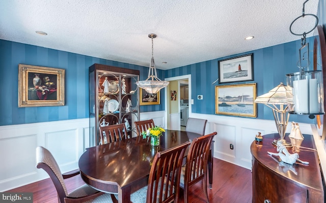 1421 Custom House Sq, Bensalem, PA 19020 - dining area featuring wood finished floors, a textured ceiling, wainscoting, and a decorative wall