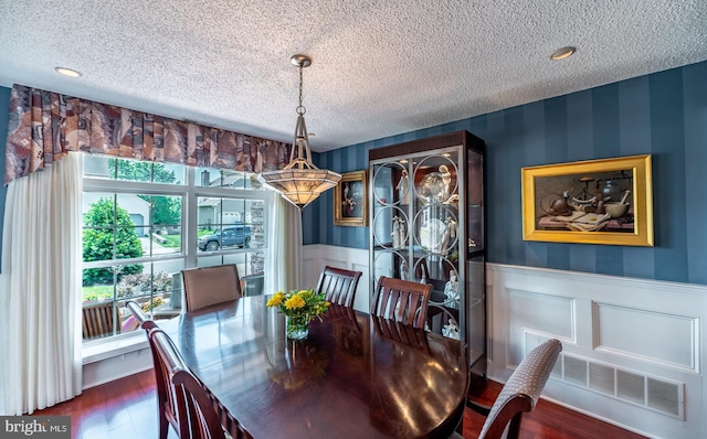 1421 Custom House Sq, Bensalem, PA 19020 - dining room with a textured ceiling, a wainscoted wall, dark wood finished floors, and wallpapered walls
