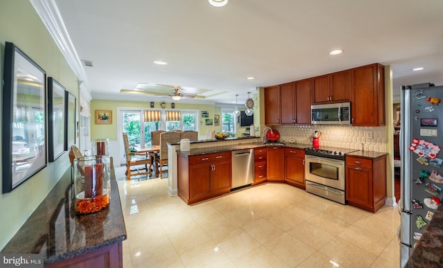 1421 Custom House Sq, Bensalem, PA 19020 - kitchen featuring stainless steel appliances, a peninsula, crown molding, ceiling fan, and backsplash