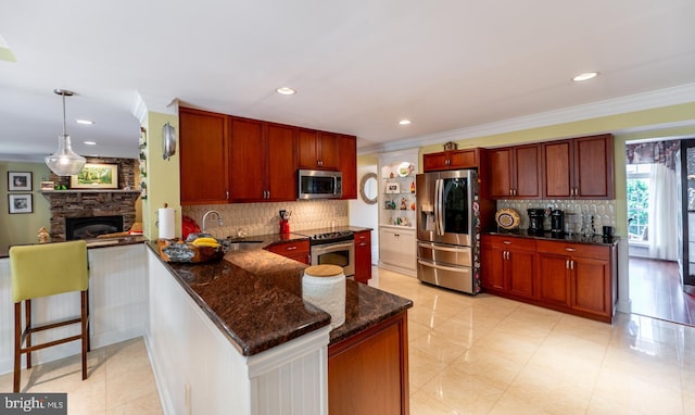 1421 Custom House Sq, Bensalem, PA 19020 - kitchen featuring appliances with stainless steel finishes, crown molding, decorative backsplash, a peninsula, and dark stone countertops