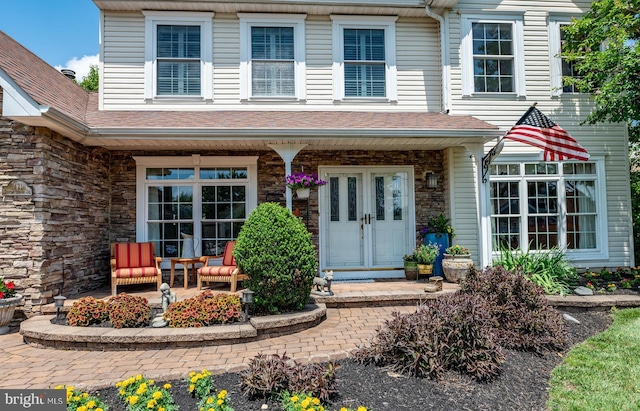 1421 Custom House Sq, Bensalem, PA 19020 - property entrance featuring stone siding, covered porch, and roof with shingles