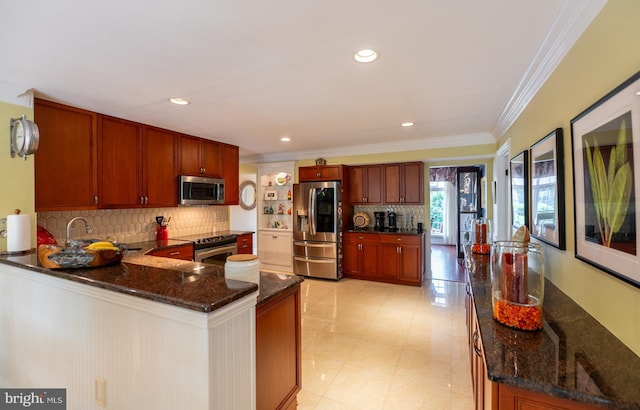 1421 Custom House Sq, Bensalem, PA 19020 - kitchen with stainless steel appliances, decorative backsplash, crown molding, dark stone countertops, and a peninsula
