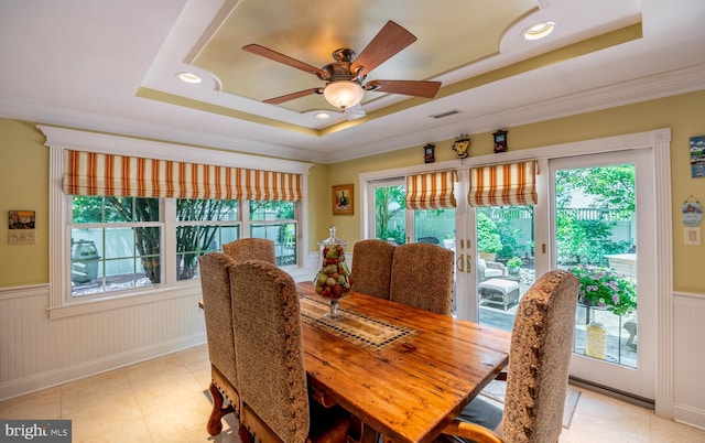 1421 Custom House Sq, Bensalem, PA 19020 - dining room with a tray ceiling, healthy amount of natural light, wainscoting, a ceiling fan, and light tile patterned floors
