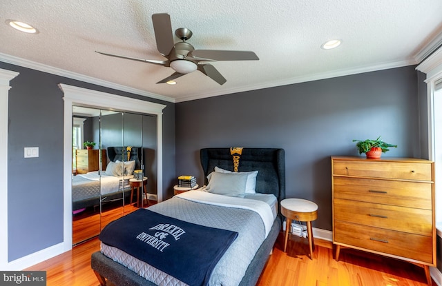 1421 Custom House Sq, Bensalem, PA 19020 - bedroom with crown molding, wood finished floors, a closet, a textured ceiling, and ceiling fan