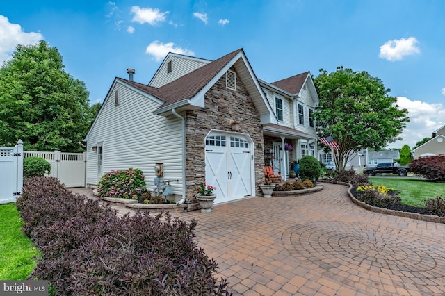 1421 Custom House Sq, Bensalem, PA 19020 - view of front of house featuring stone siding, decorative driveway, and a gate