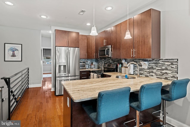 2115 Carpenter St Unit 1, Philadelphia, PA 19146 - kitchen with appliances with stainless steel finishes, a peninsula, recessed lighting, backsplash, and pendant lighting