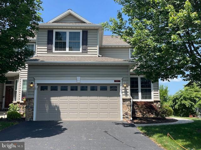 1501 Lexington Way, Morgantown, PA 19543 - view of front facade with an attached garage, asphalt driveway, stone siding, and roof with shingles