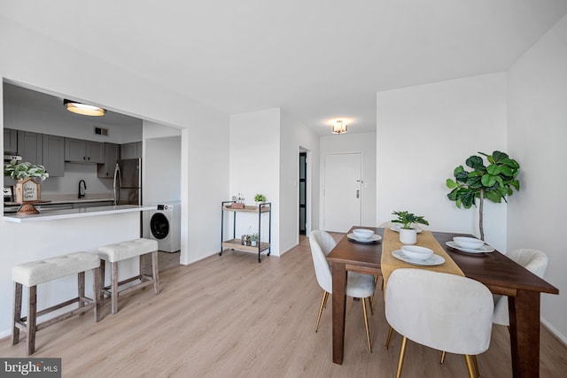 5500 Holmes Run Pkwy Unit 1103, Alexandria, VA 22304 - dining space featuring washer / dryer and light wood finished floors