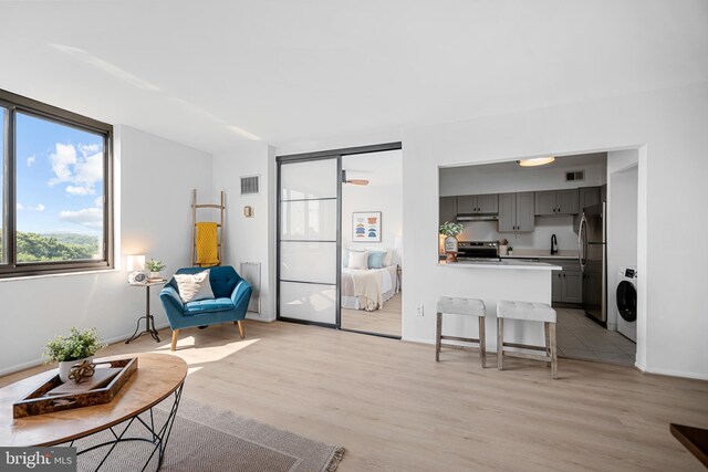 5500 Holmes Run Pkwy Unit 1103, Alexandria, VA 22304 - living area featuring washer / clothes dryer and light wood-style flooring