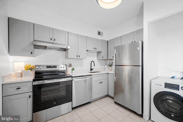 5500 Holmes Run Pkwy Unit 1103, Alexandria, VA 22304 - kitchen with appliances with stainless steel finishes, washer / dryer, under cabinet range hood, gray cabinetry, and light countertops