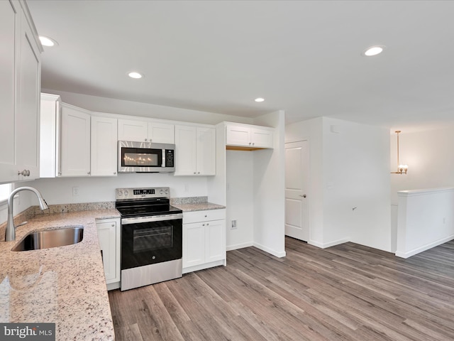 564 Monocacy Trl, Spring Grove, PA 17362 - kitchen with stainless steel appliances, white cabinets, light wood-type flooring, light stone counters, and recessed lighting