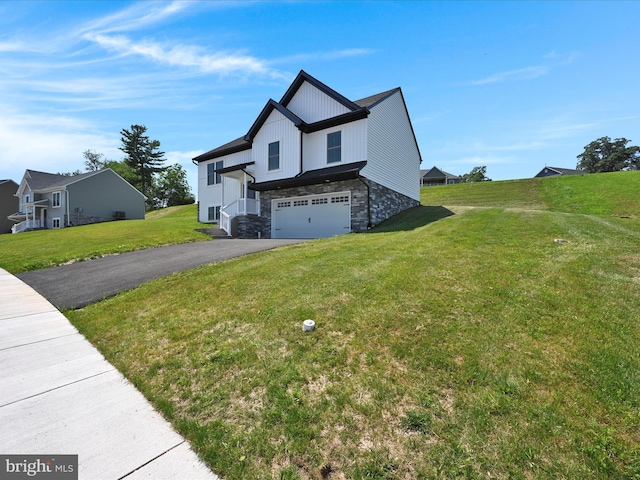 564 Monocacy Trl, Spring Grove, PA 17362 - view of home's exterior with stone siding, an attached garage, asphalt driveway, and a yard