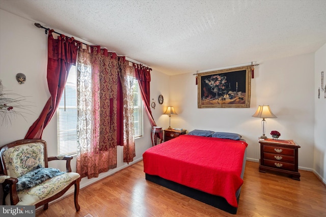 119 Prosperity Ave SE Unit C, Leesburg, VA 20175 - bedroom featuring a textured ceiling and wood finished floors