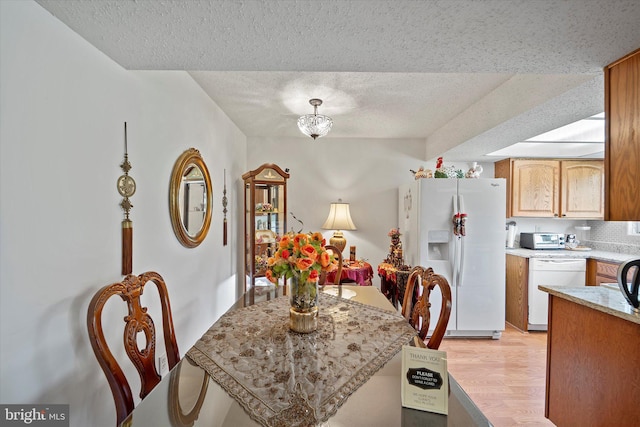 119 Prosperity Ave SE Unit C, Leesburg, VA 20175 - dining room with a textured ceiling and light wood-style flooring