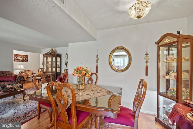 119 Prosperity Ave SE Unit C, Leesburg, VA 20175 - dining area featuring light wood finished floors and a textured ceiling