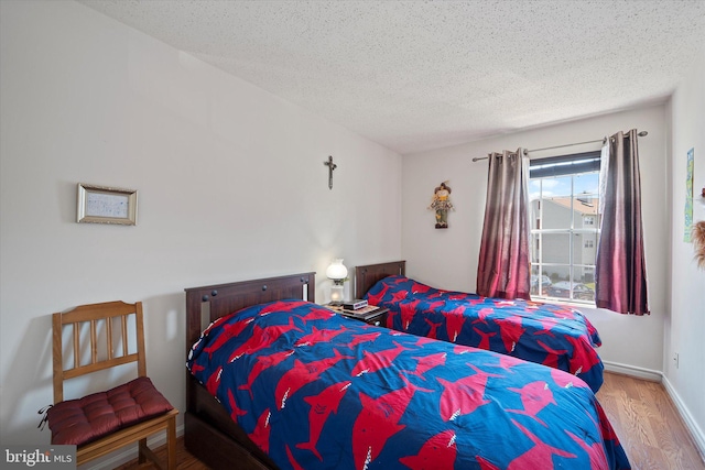 119 Prosperity Ave SE Unit C, Leesburg, VA 20175 - bedroom with wood finished floors and a textured ceiling