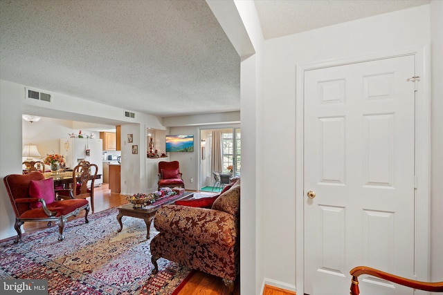 119 Prosperity Ave SE Unit C, Leesburg, VA 20175 - living room with a textured ceiling and light wood-style flooring