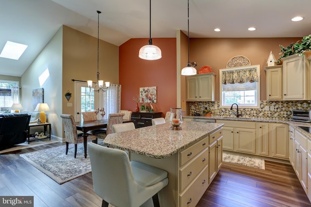 6210 Thornhill Ln, Mechanicsburg, PA 17050 - kitchen with high vaulted ceiling, a center island, a chandelier, a skylight, and light stone countertops