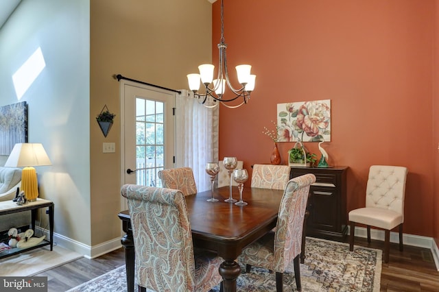 6210 Thornhill Ln, Mechanicsburg, PA 17050 - dining space with a chandelier, wood finished floors, and a towering ceiling
