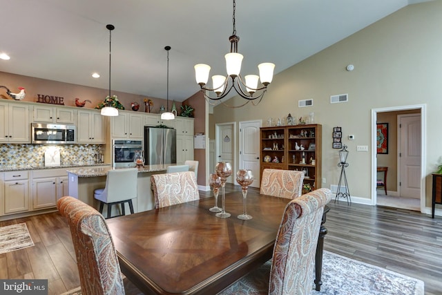 6210 Thornhill Ln, Mechanicsburg, PA 17050 - dining area with high vaulted ceiling, wood finished floors, a chandelier, and recessed lighting