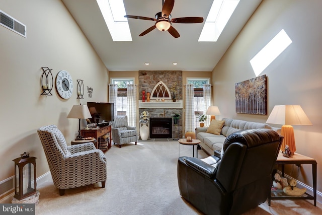 6210 Thornhill Ln, Mechanicsburg, PA 17050 - carpeted living room featuring a skylight, a ceiling fan, a stone fireplace, and high vaulted ceiling