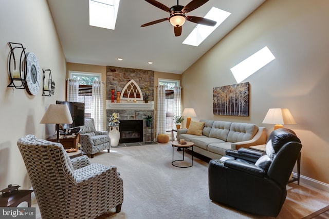 6210 Thornhill Ln, Mechanicsburg, PA 17050 - living room featuring a skylight, carpet flooring, ceiling fan, a stone fireplace, and high vaulted ceiling