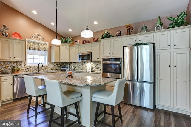 6210 Thornhill Ln, Mechanicsburg, PA 17050 - kitchen featuring appliances with stainless steel finishes, decorative backsplash, vaulted ceiling, dark wood-type flooring, and a center island