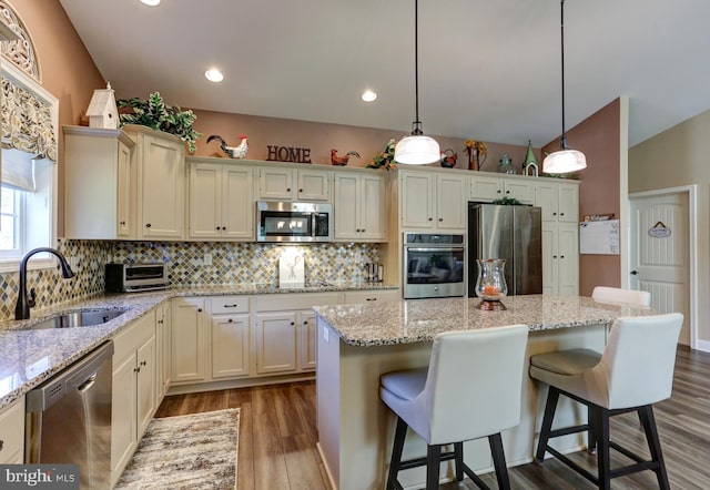 6210 Thornhill Ln, Mechanicsburg, PA 17050 - kitchen featuring appliances with stainless steel finishes, backsplash, dark wood-style flooring, a kitchen island, and recessed lighting