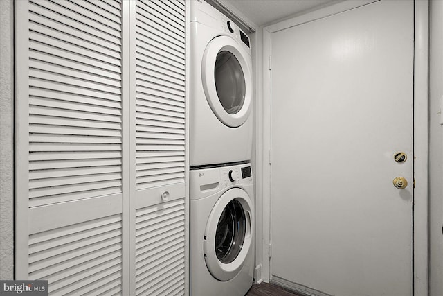 4 46th St Unit 101, Ocean City, MD 21842 - laundry area featuring stacked washer and clothes dryer and wood finished floors