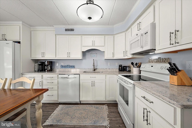 4 46th St Unit 101, Ocean City, MD 21842 - kitchen with white appliances, dark wood-type flooring, white cabinets, and crown molding