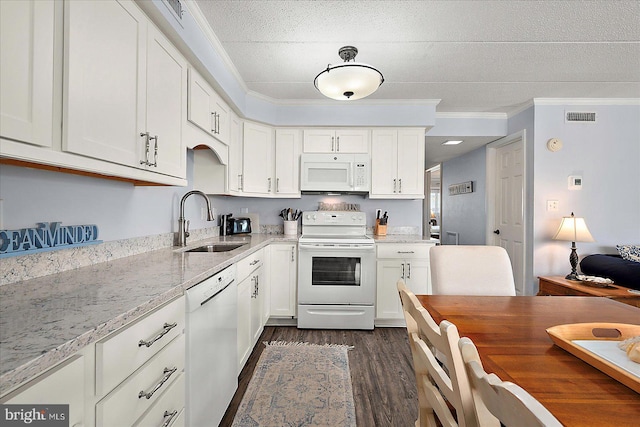4 46th St Unit 101, Ocean City, MD 21842 - kitchen featuring white appliances, ornamental molding, dark wood finished floors, white cabinetry, and light stone counters