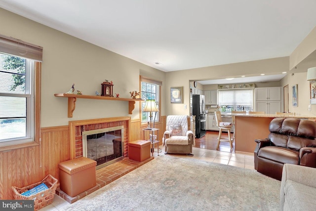 78 Kent Ave, Marlton, NJ 08053 - living room featuring a wainscoted wall, a fireplace, wooden walls, and light tile patterned floors