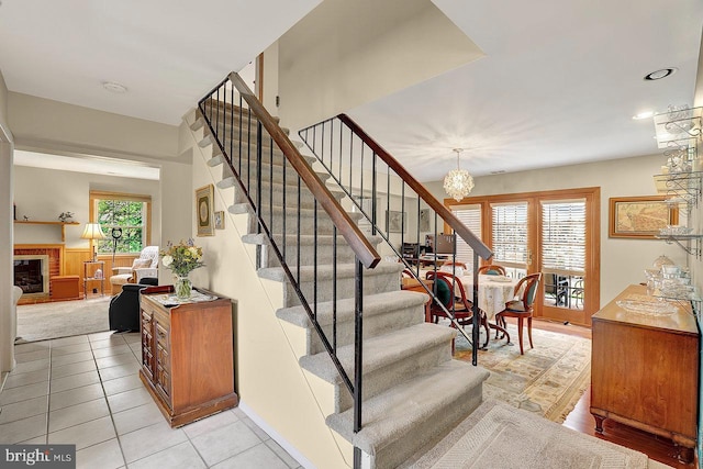 78 Kent Ave, Marlton, NJ 08053 - staircase with a chandelier, tile patterned floors, recessed lighting, and a fireplace