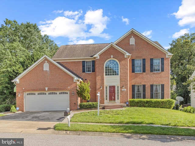 1505 Ridge Forest Way, Hanover, MD 21076 - colonial house featuring asphalt driveway, brick siding, a front yard, and a garage