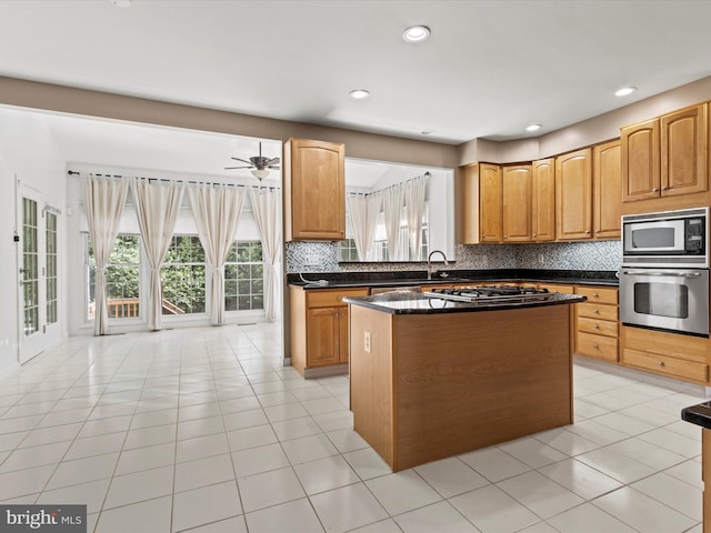 1505 Ridge Forest Way, Hanover, MD 21076 - kitchen with stainless steel appliances, tasteful backsplash, a kitchen island, a ceiling fan, and light tile patterned floors
