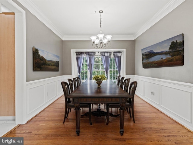 1505 Ridge Forest Way, Hanover, MD 21076 - dining space featuring a chandelier, crown molding, light wood-type flooring, wainscoting, and a decorative wall