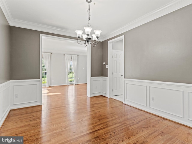 1505 Ridge Forest Way, Hanover, MD 21076 - unfurnished dining area with a chandelier, ornamental molding, light wood finished floors, wainscoting, and a decorative wall