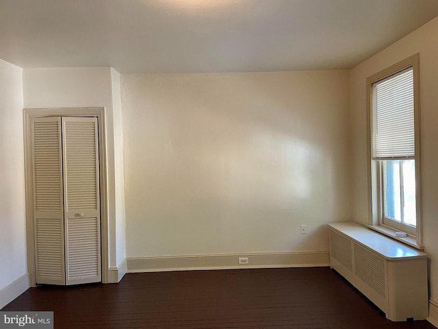 363 New St, Pottstown, PA 19464 - unfurnished bedroom with radiator heating unit, dark wood-style flooring, and a closet