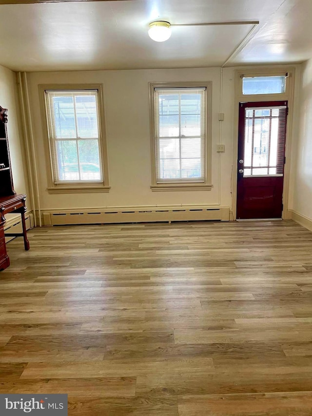 363 New St, Pottstown, PA 19464 - unfurnished dining area featuring light wood-style floors, a baseboard radiator, and a baseboard heating unit