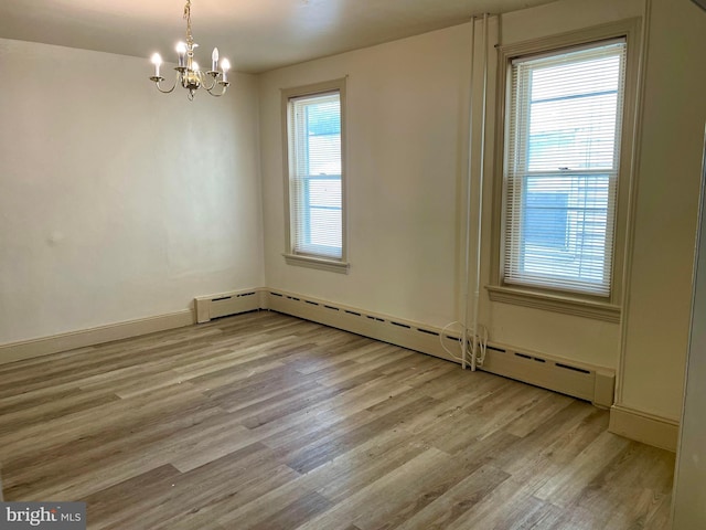 363 New St, Pottstown, PA 19464 - unfurnished room featuring baseboard heating, light wood-type flooring, and a chandelier