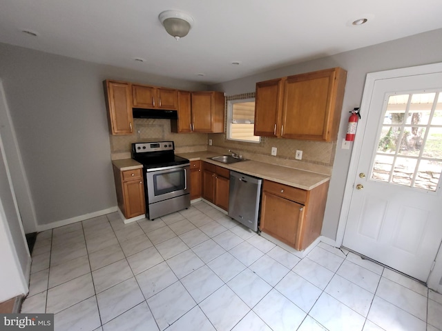 666 Manatawny St, Pottstown, PA 19464 - kitchen with stainless steel appliances, light countertops, decorative backsplash, and healthy amount of natural light