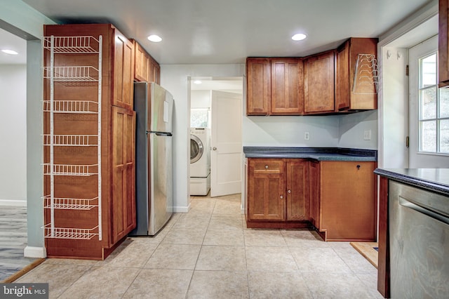 328 E Logan St, Bellefonte, PA 16823 - kitchen featuring stainless steel appliances, washer / dryer, dark countertops, brown cabinets, and recessed lighting