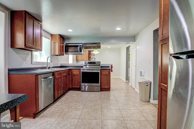 328 E Logan St, Bellefonte, PA 16823 - kitchen with stainless steel appliances, dark countertops, light tile patterned floors, recessed lighting, and a peninsula