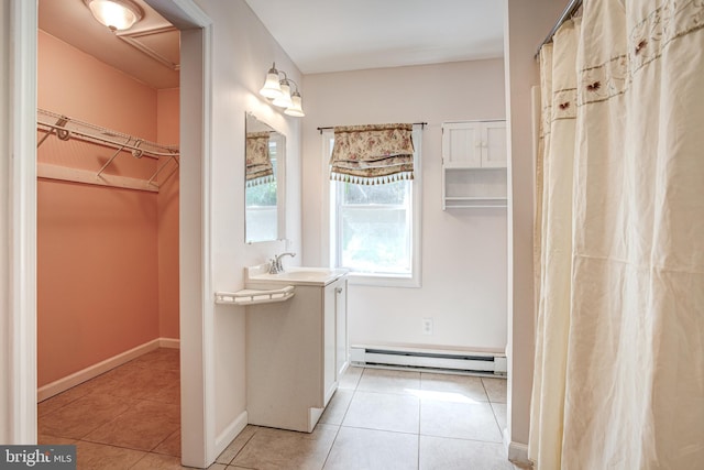 328 E Logan St, Bellefonte, PA 16823 - full bath with baseboard heating, tile patterned flooring, a spacious closet, and vanity