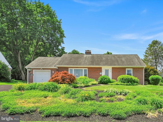 1402 Springside Dr, Lancaster, PA 17603 - view of front of house featuring brick siding, a garage, a chimney, a shingled roof, and asphalt driveway