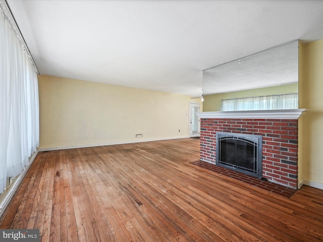 1402 Springside Dr, Lancaster, PA 17603 - unfurnished living room featuring hardwood / wood-style floors and a brick fireplace