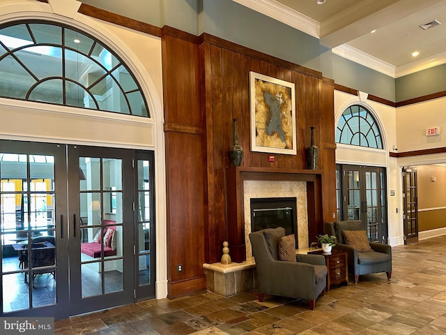 2465 Army Navy Dr Unit 1-302, Arlington, VA 22206 - living area with french doors, a towering ceiling, stone tile flooring, crown molding, and a premium fireplace