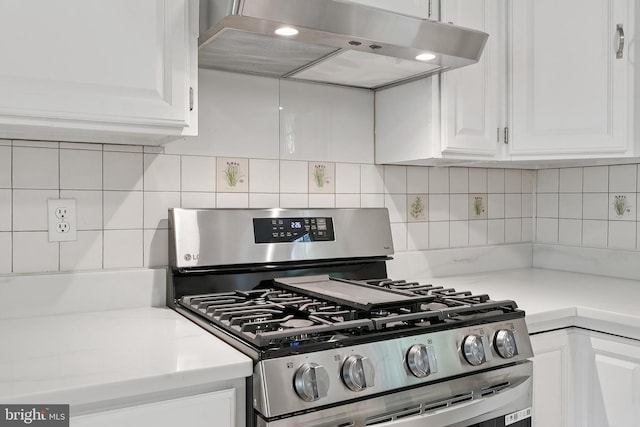 11704 Milbern Dr, Potomac, MD 20854 - kitchen with stainless steel gas range, extractor fan, white cabinetry, and light countertops